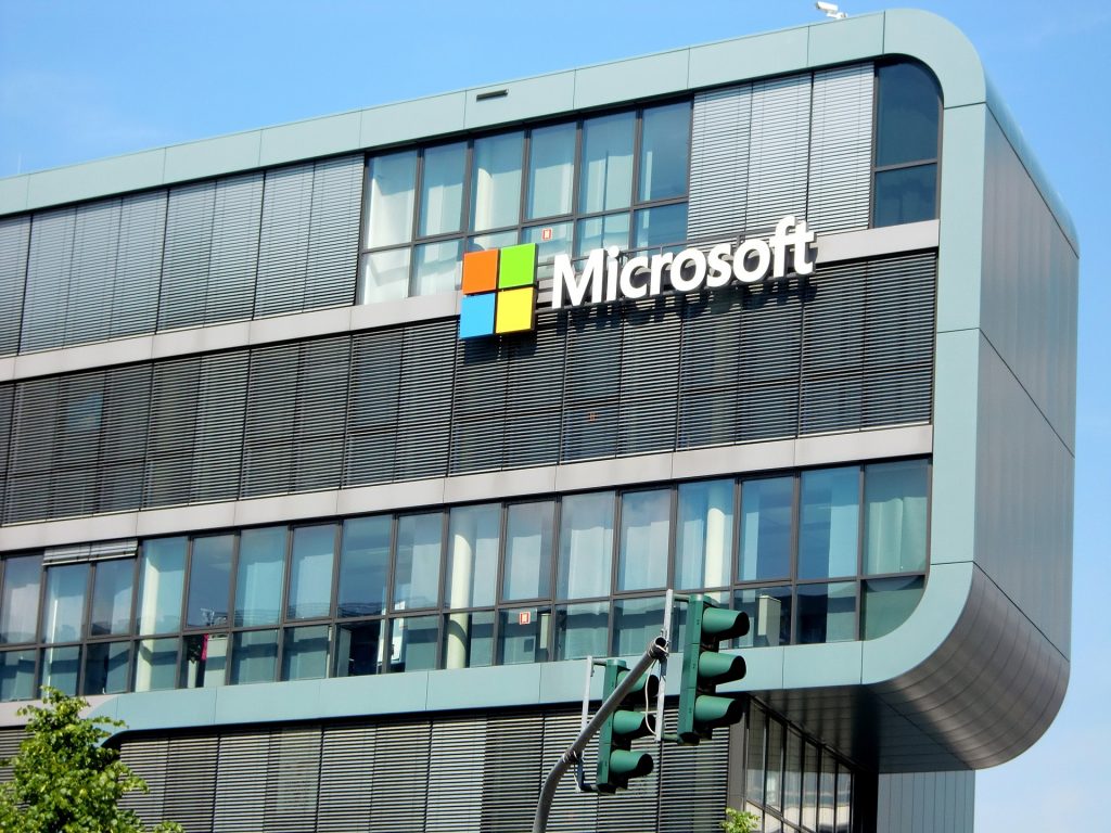 A large glass building with a "Microsoft" sign on one side.